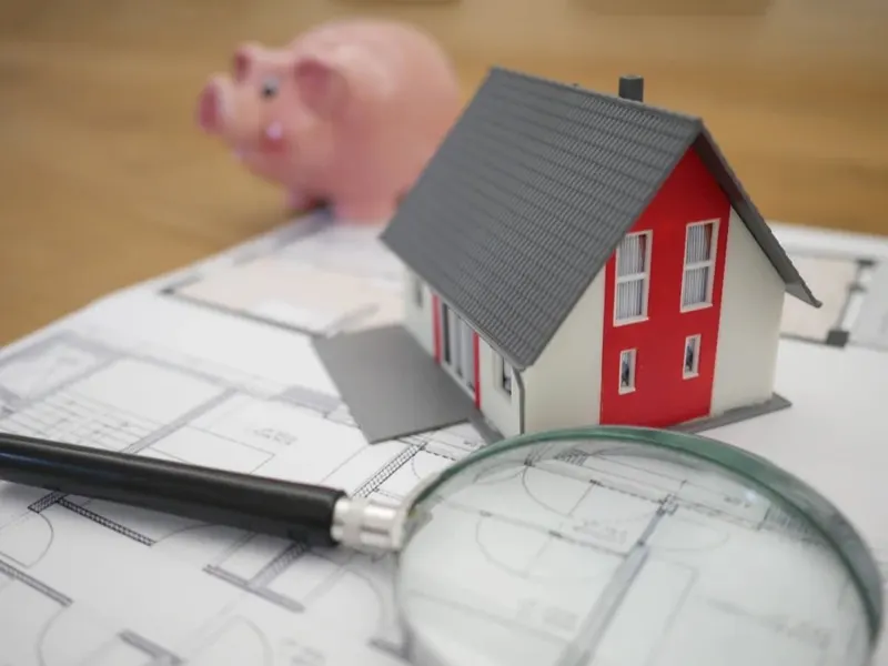 A home, piggy bank and house plans